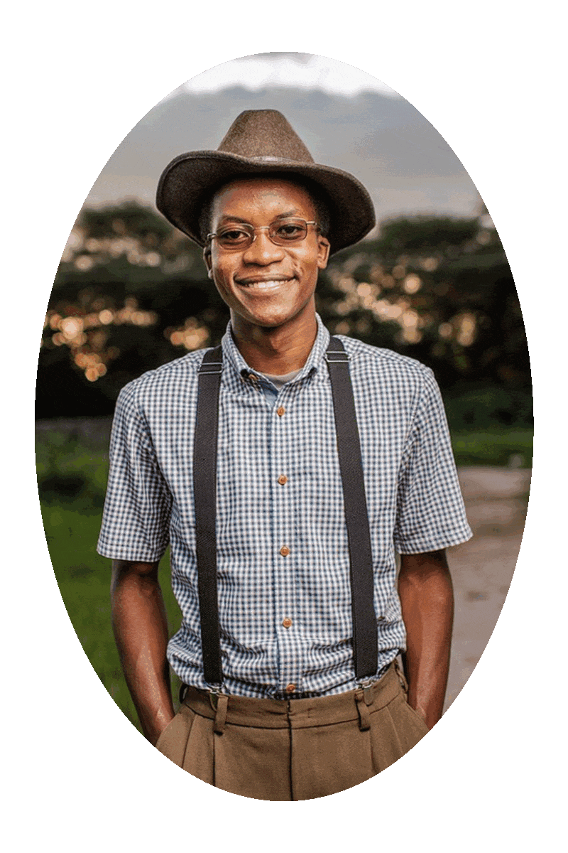 Picture of a happy smiling man wearing a short-sleeve shirt, brown pants, suspenders, hat, and eyeglasses.