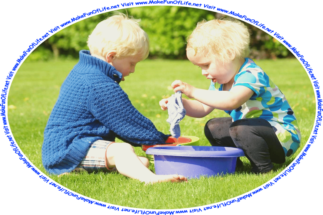 Picture of two toddlers, a boy and a girl, sitting in a green grassy lawn outdoors, washing fabric pieces in plastic tubs, and the words, ‘Visit www.MakeFunOfLife.net.’